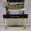 KONSOLA Naomi z dwiema szufladami, czarny połyskujący blat, złoty stelaż, styl glamour 120 cm