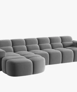 NAROŻNIK Lisa z krótkim bokiem w jasnoszarej, aksamitnej tkaninie, przeszywany, zaoblone kształty, designerski styl, piękny
