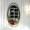 LUSTRO ŚCIENNE Aurelia Oval w owalnej złotej, błyszczącej ramie ze stali nierdzewnej, designerski styl